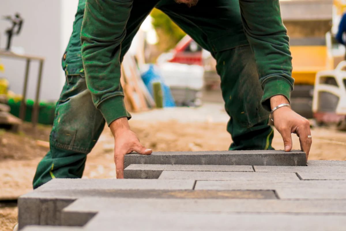 Landscaper installing garden paving stones